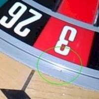 On the picture is a roulette wheel in a casino, with a visible flaw (with a green circle around it), leading to wheel bias. You can read about wheel bias right next to the picture. Also, the picture also acts as a link, by clicking on it you will be taken to a webpage with a video tutorial that will teach you how to exploit wheel bias (opens in a new tab).