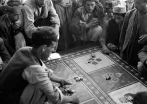 This is a picture of group of Afghan men participating in illegal gambling, betting on a traditional carrom game. Apart form illegal animal fights, illegal betting on carrom seem to be also popular. You can read more about the various illegal forms of terrestrial and internet gambling in Afghanistan to the left of he picture. A list of online gambling websites, which accept players from Afghanistan is also included as well on this page.