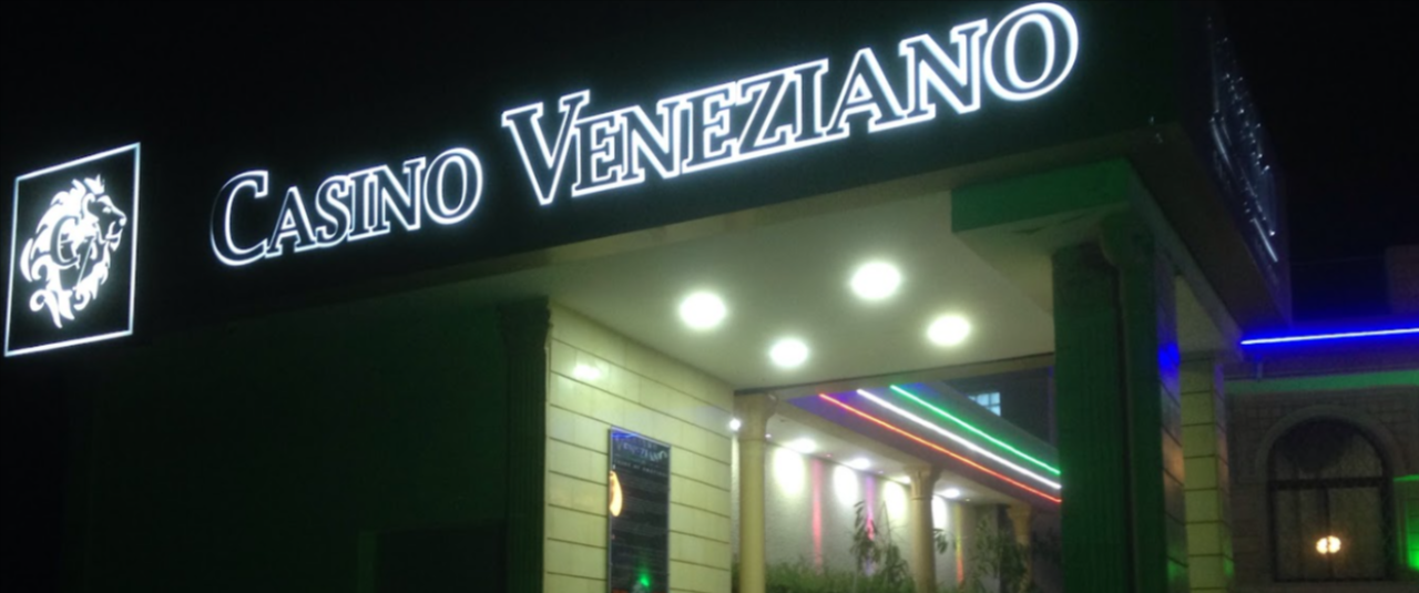 This photo of front entrance and logo of Casino Veneziano in Sousse. Under the picture, on this page, you can read about the legal status of the various forms of Tunisia games of chance: internet lottery, digital bingo, electronic poker, sports betting, crypto wagering. There is also info about illegal gambling, betting on blood sports, the licensing system, taxation regime, and you can find a list of licensed online gambling websites, which accept Tunisian players.