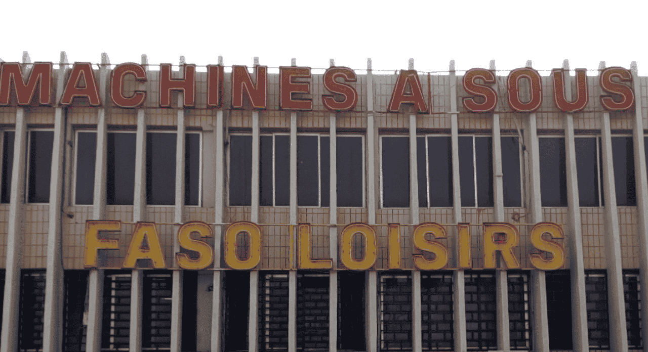 This photo is of Faso Loisirs a gambling establishment in Ouagadougou, the capital of Burkina Faso. Under the picture, on this page, you can read about the legal status of the various forms of Burkina Faso games of chance: internet lottery, digital bingo, electronic poker, sports betting, crypto wagering. There is also info about illegal gambling, sharia law and betting on blood sports, the licensing system, taxation regime, and you can find a list of licensed online gambling websites, which accept Burkinabe players.