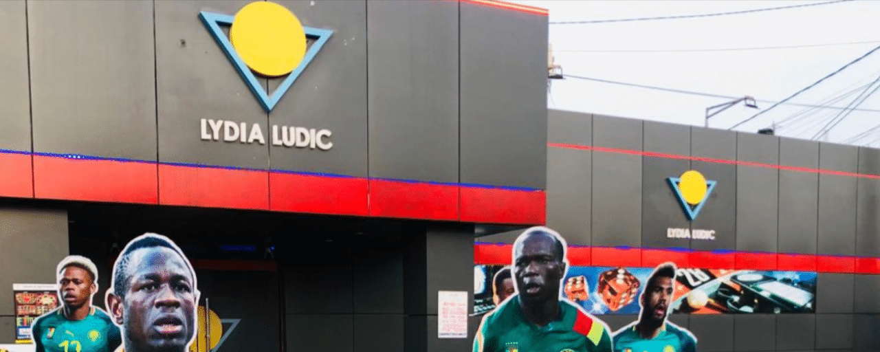 This photo of front entrance and logo of one of the many Lydia Ludic gambling venues in Lóme, the capital of the Togolese Republic. Under the picture, on this page, you can read about the legal status of the various forms of Togo games of chance: internet lottery, digital bingo, electronic poker, sports betting, crypto wagering. There is also info about illegal gambling, betting on blood sports, the licensing system, taxation regime, and you can find a list of licensed online gambling websites, which accept Togolese players.
