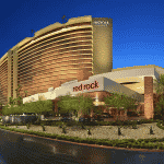 This is a picture of the building of Red Rock Casino Resort Spa, which is the biggest land-based casino in Nevada. Next to the picture, you can read about the gambling establishments, the legal status of online casinos, crypto casinos and tribal casinos in NV, taxation of winnings and legal gambling age in the state.