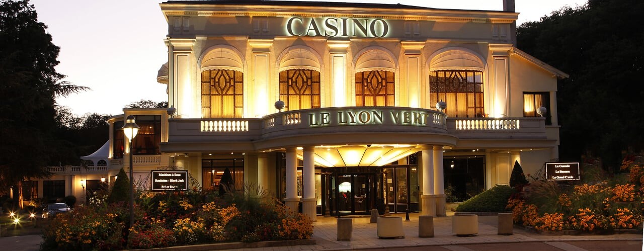 This is a picture of the exterior and front entrance of Casino Le Lyon Vert, a typical French casino hotel in La Tour-de-Salvagny, République française. Under the picture, on this page, you can read about the legal status of the various forms of France games of chance: internet lottery, digital bingo, electronic poker, sports betting, crypto wagering. There is also info about illegal gambling, betting on blood sports, the licensing system, taxation regime, and you can find a list of licensed online gambling websites, which accept French players.