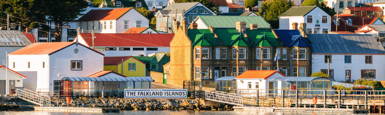 This is a picture of the port of Stanley, the capital of the Falkland Islands. On this page, you can read about the legislation, rules, licensing, taxation of of the various forms of games of chance and online gambling in the country, including: poker, bingo, lottery, sports betting, cryptocurrency wagering, and a list of online gambling sites which accept players from the Falkland Islands.