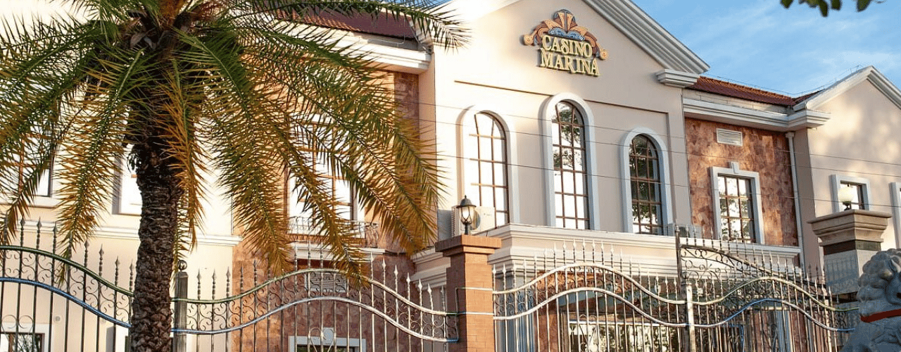 This a photo of the exterior and building of Casino Marina in Antananarivo, the capital of the Republic of Madagascar. Under the picture, on this page, you can read about the legal status of the various forms of Madagascar games of chance: internet lottery, digital bingo, electronic poker, sports betting, crypto wagering. There is also info about illegal gambling, betting on blood sports, the licensing system, taxation regime, and you can find a list of licensed online gambling websites, which accept Madagascan players.