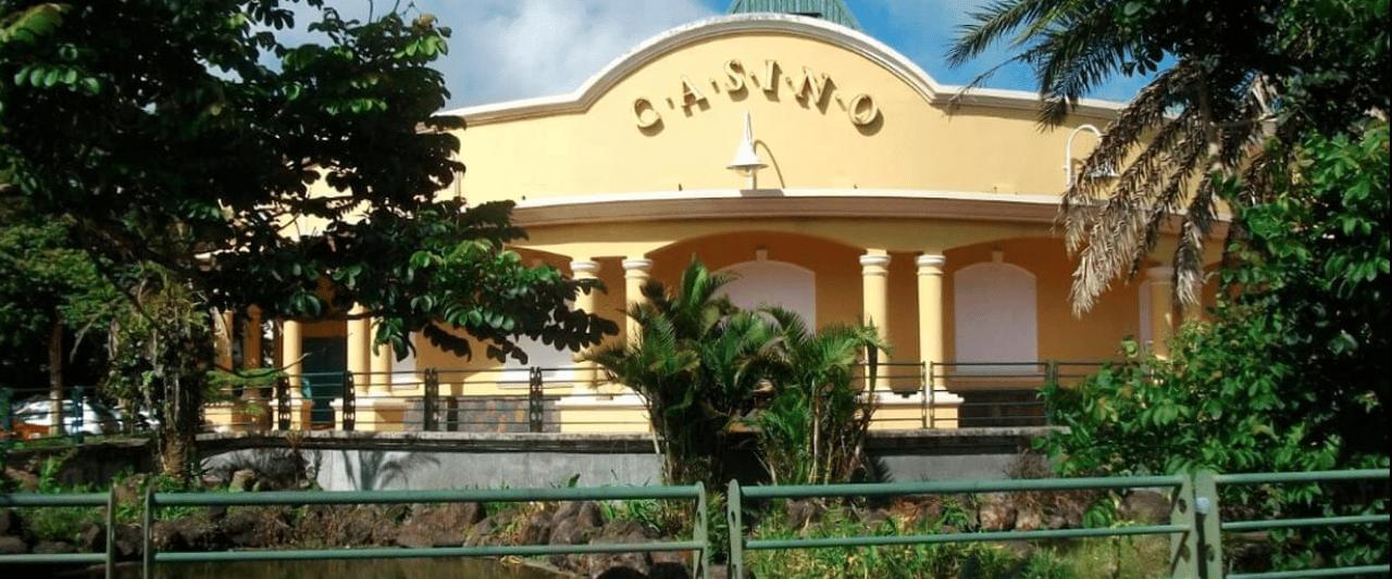 This a photo of the front entrance of Mauritius Casino in Curepipe, in the Republic of Mauritius. Under the picture, on this page, you can read about the legal status of the various forms of Mauritius games of chance: internet lottery, digital bingo, electronic poker, sports betting, crypto wagering. There is also info about illegal gambling, betting on blood sports, the licensing system, taxation regime, and you can find a list of licensed online gambling websites, which accept Mauritian players.