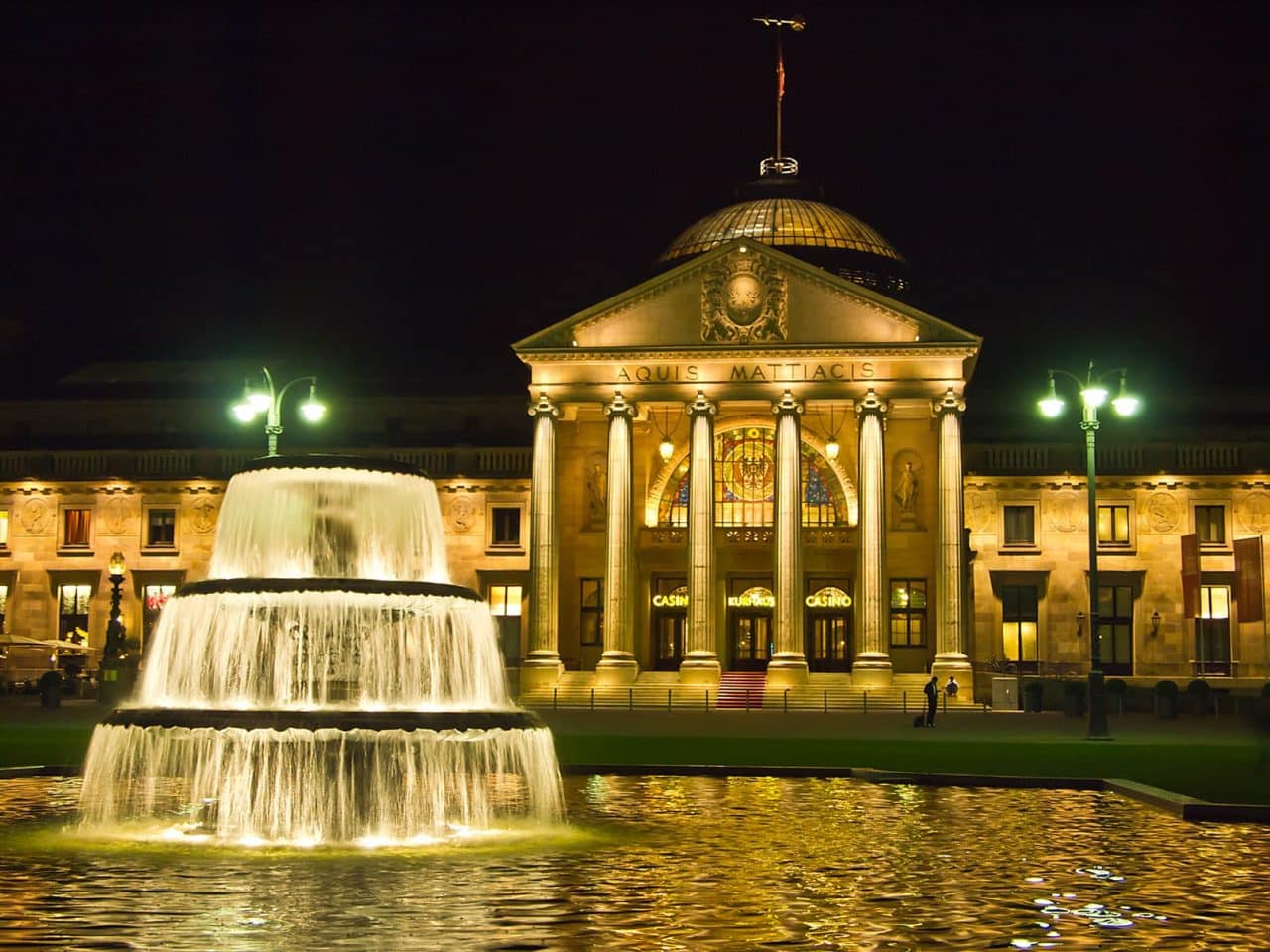 This is a picture of Kurhaus Wiesbaden at night, in Wiesbaden, Hesse, Germany's oldest in continuous operation gambling establishment (in operation since 1810, the second ever to open casino in the Republic of Germany). On this page, under the picture you can read about the legal status, licensing and taxation of online sports betting, digital poker, electronic bingo, internet lottery, cryptocurrency wagering websites in Germany. Additionally a list of Germany licensed online gambling websites are included as well, which accept players from the country. 