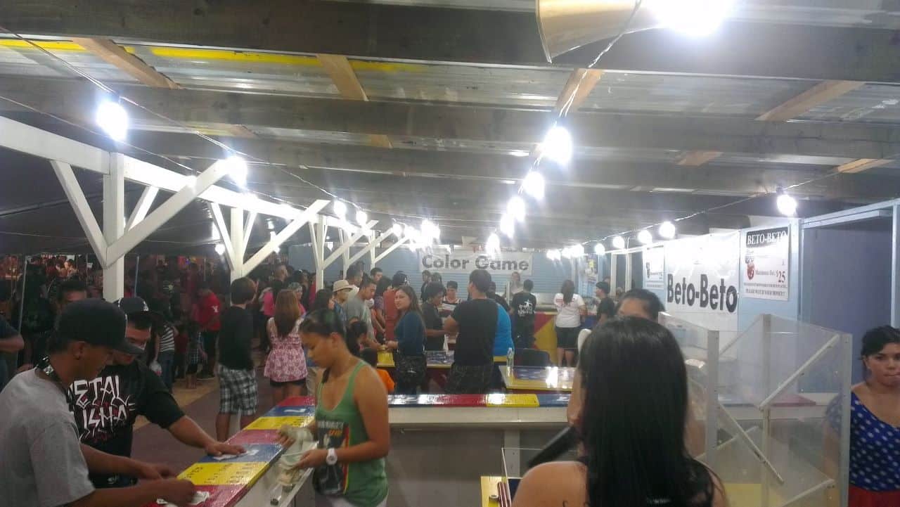 This is a picture of Guam's Liberation Day Carnival with Beto-beto and color game stalls visible, in the capital of Hagåtña. You can read about gambling (which is mostly illegal) in Guam, online gambling, poker, bingo, lottery, sports betting laws, rules, legislation, licensing, taxation.