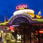 This is a picture of the very decorative front entrance of Casino d'Evian. To the right of the picture is a description of the casino and its address., opening hours, dress code and a video.