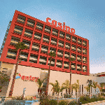 This is a picture of the front entrance of building of Antay Casino & Hotel in Copiapo, in the province of Atacama. To the right of the picture you can read more about this casino, details including: address, opening hours, number and types of games.