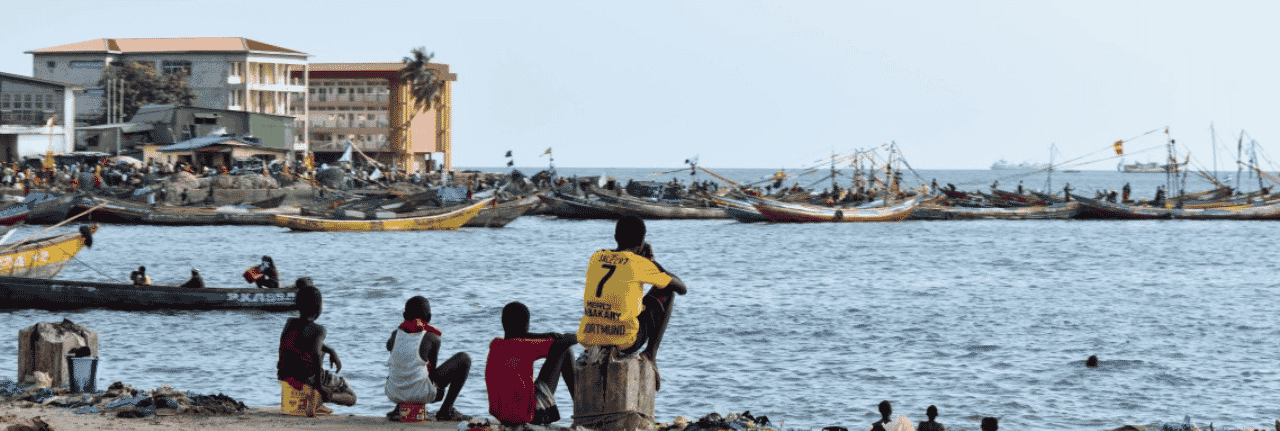 This is a photo of a beach, hotels and fishing boats near Conakry, the capital of the Republic of Guinea. Under this picture, on this page, you can find a list of all terrestrial Guinean casinos, info about the legal status of gaming venues, slot halls, their taxation regime, licensing system, and you can find a list of Guinea licensed online casinos, which accept players from the country.