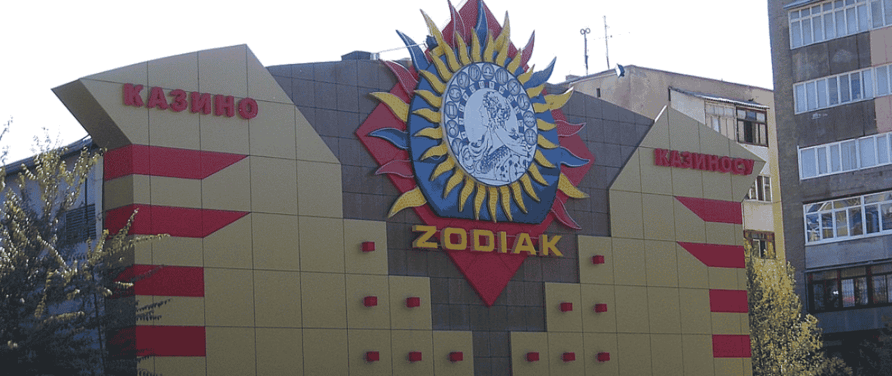 This is a picture of the front entrance, facade and sign of the former Zodiak Casino, in the capital of the Kyrgyz Republic, Bishkek. This casino gaming venue used to be the biggest casino of the country, it is no longer in operation since the 2011 gambling ban. Under this picture, on this page, you can find a list of all terrestrial Kyrgyz casinos, info about the legal status of gaming venues, slot halls, their taxation regime, licensing system, and you can find a list of Kyrgyzstan licensed online casinos, which accept players from the country.