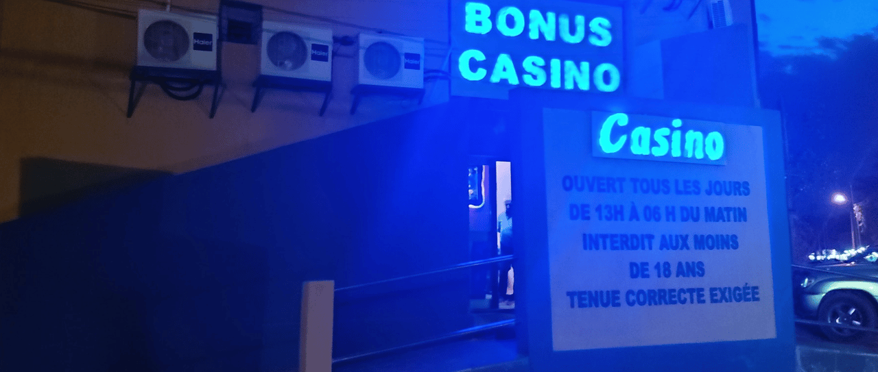 This is a photo of the building of the front entrance and neon sign of Casino Bonus in Niamey, the capital of the Republic of the Niger. Under this picture, on this page, you can find a list of all terrestrial Nigerien casinos, info about the legal status of gaming venues, slot halls, their taxation regime, licensing system, and you can find a list of Niger licensed online casinos, which accept players from the country.