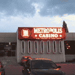 This is a picture of the lit neon sign of Metropolis Casino in Timisoara. This is the third element on this list of all 5 casinos of Romania. You can find the other venues above and below this one. You can read the details of this casino next to the picture, including address, opening hours, number of games, dress code, entrance fee, a video of the venue and reviews.
